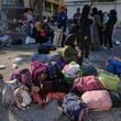 Families gather in Martyrs' square after fleeing the Israeli airstrikes in Beirut's southern suburbs, Saturday, Sept. 28, 2024. (AP Photo/Bilal Hussein)