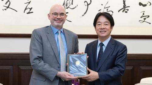 In this photo released by the Taiwan Presidential Office, Taiwan's President William Lai Ching-te, right pose for photos with American Institute in Taiwan's (AIT) director Greene F. Raymond in Taipei, Taiwan on July 10, 2024. Raymond who newly assumed his office on July 9, met with Taiwan President William Lai in the morning of July 10, when both reiterated on the strong partnership Taiwan and the U.S. nurtured from the past, with ups and downs. (Taiwan Presidential Office via AP)