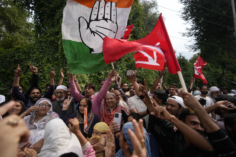 Supporters of Indian National Congress and National Conference party celebrate early leads in election outside a counting center on the outskirts of Srinagar, Indian controlled Kashmir, Tuesday, Oct. 8, 2024. (AP Photo/Mukhtar Khan)