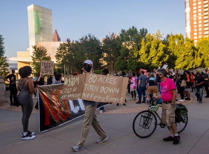 Protestors march in opposition to the proposed training center. (Jenni Girtman for The Atlanta Journal-Constitution)