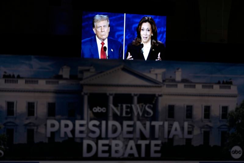 A presidential debate between Republican presidential nominee former President Donald Trump, on screen at left, and Democratic presidential nominee Vice President Kamala Harris, right, is seen from the spin room, Tuesday, Sept. 10, 2024, in Philadelphia. (AP Photo/Matt Slocum)