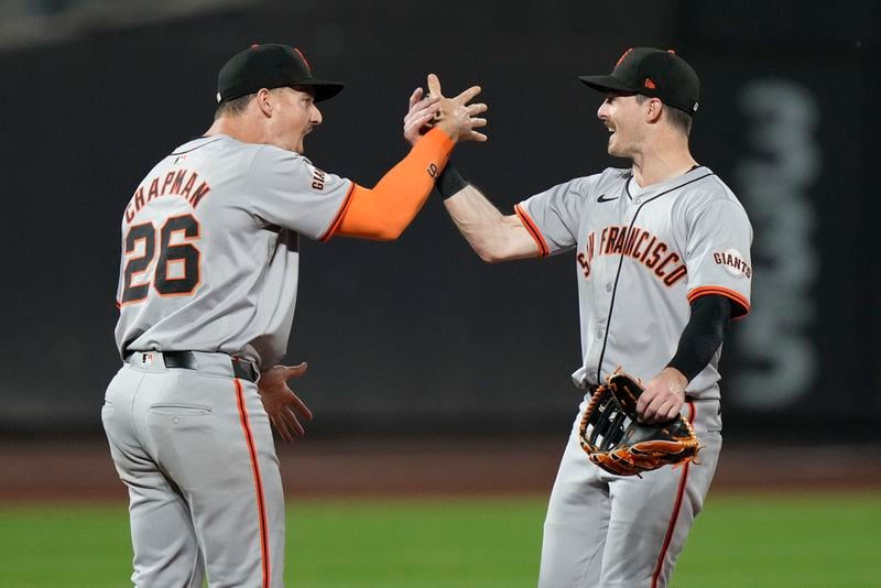 San Francisco Giants' Matt Chapman, left, celebrates with Mike Yastrzemski, right, after a baseball game against the New York Mets, Friday, May 24, 2024, in New York. (AP Photo/Frank Franklin II)