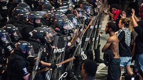 CHARLOTTE, NC - SEPTEMBER 21: Police officers in riot gear approach demonstrators September 21, 2016 in downtown Charlotte, NC. Protests in Charlotte began on Tuesday in response to the fatal shooting of 43-year-old Keith Lamont Scott at an apartment complex near UNC Charlotte. (Photo by Sean Rayford/Getty Images)