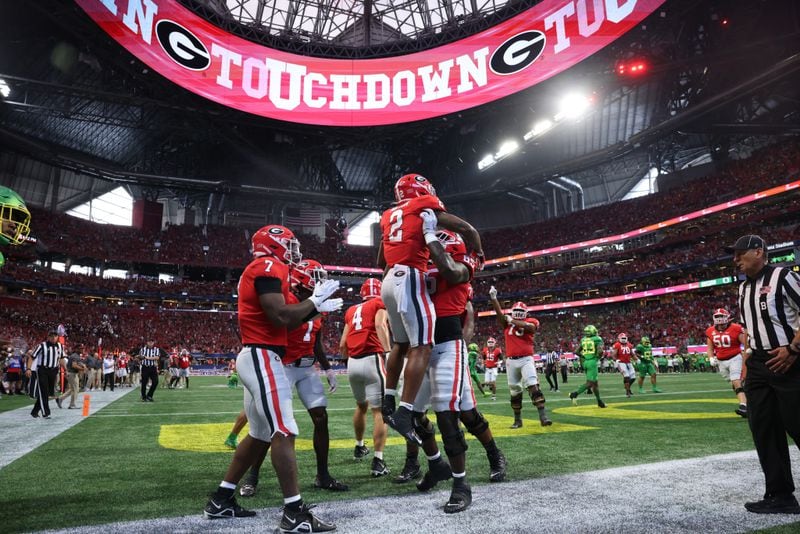 Georgia Bulldogs running back Kendall Milton (2) celebrates his eighteen-yard touchdown catch and run with offensive lineman Amarius Mims (65) during the fourth quarter against the Oregon Ducks in the Chick-fil-A Kickoff game at Mercedes Benz Stadium, Saturday, September 3, 2022, in Atlanta. Georgia won 49-3. (Jason Getz / Jason.Getz@ajc.com)