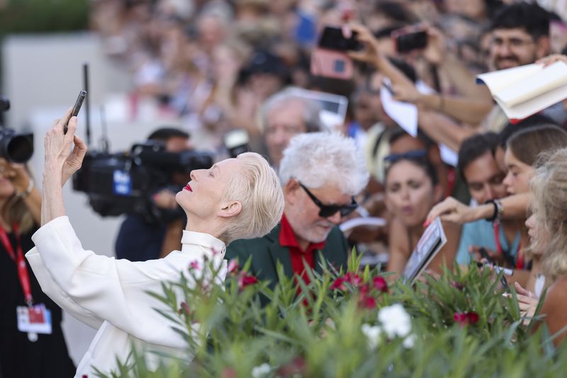 Tilda Swinton takes a selfie upon arrival for the premiere of the film 'Queer' during the 81st edition of the Venice Film Festival in Venice, Italy, on Tuesday, Sept. 3, 2024. (Photo by Vianney Le Caer/Invision/AP)