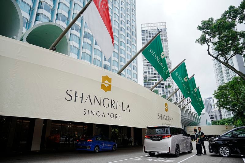 Police officers guard near the entrance of the Shangri-La Hotel, the venue for the 21th International Institute for Strategic Studies (IISS) Shangri-La Dialogue, Asia's annual defense and security forum, in Singapore, Friday, May 31, 2024. (AP Photo/Vincent Thian)