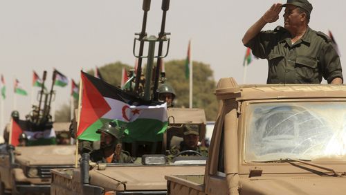 FILE - A Polisario Front soldier salutes during a military parade to celebrate the 50th anniversary of the Polisario Front in the Aoussered camp, Algeria, Saturday, May 20, 2023. France has recognized Morocco's sovereignty over the disputed Western Sahara, shifting a decades-held position and adding itself to a growing list of countries to back Morocco while a United Nations-mediated peace process remains stalled, French President Emmanuel Macron wrote in a letter made public on Tuesday, July 30, 2024. (AP Photo/Guidoum Fateh, File)