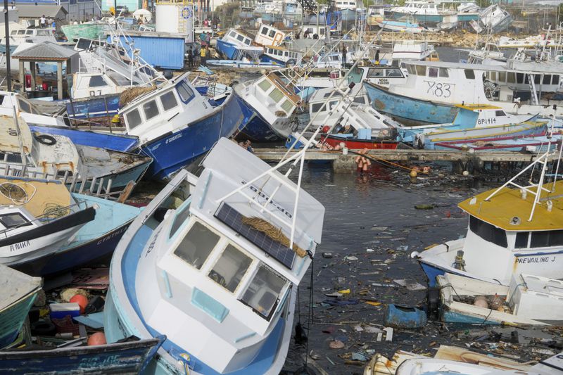 Fishing vessels damaged by Hurricane Beryl sit upended at the Bridgetown Fisheries in Barbados, Monday, July 1, 2024. (AP Photo/Ricardo Mazalan)