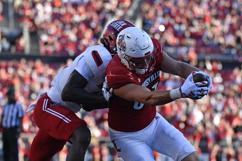 Jacksonville State linebacker Jibreel Al-Amin (15) attempts to stop Louisville tight end Mark Redman (83) from reaching across the goal line to score during the second half of an NCAA college football game in Louisville, Ky., Saturday, Sept. 7, 2024. (AP Photo/Timothy D. Easley)