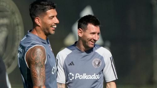 Inter Miami forwards Lionel Messi, right, and Luis Suarez, share a laugh as the work out at the MLS soccer team's training facility, Friday, Sept. 13, 2024, in Fort Lauderdale, Fla. (AP Photo/Wilfredo Lee)