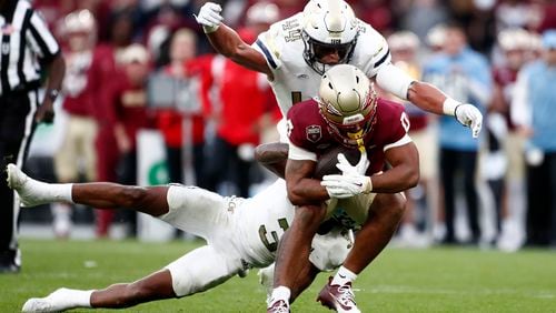 Florida's Ja'Khi Douglas is tackled during the NCAA college football game between Georgia Tech and Florida State at the Aviva stadium in Dublin, Saturday, Aug. 24, 2024. (AP Photo/Peter Morrison)