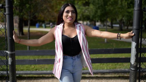 Julieth Luna Garcia, a transgender woman from El Salvador, poses for photos at Horner Park in Chicago, Monday, Sept. 30, 2024. (AP Photo/Nam Y. Huh)