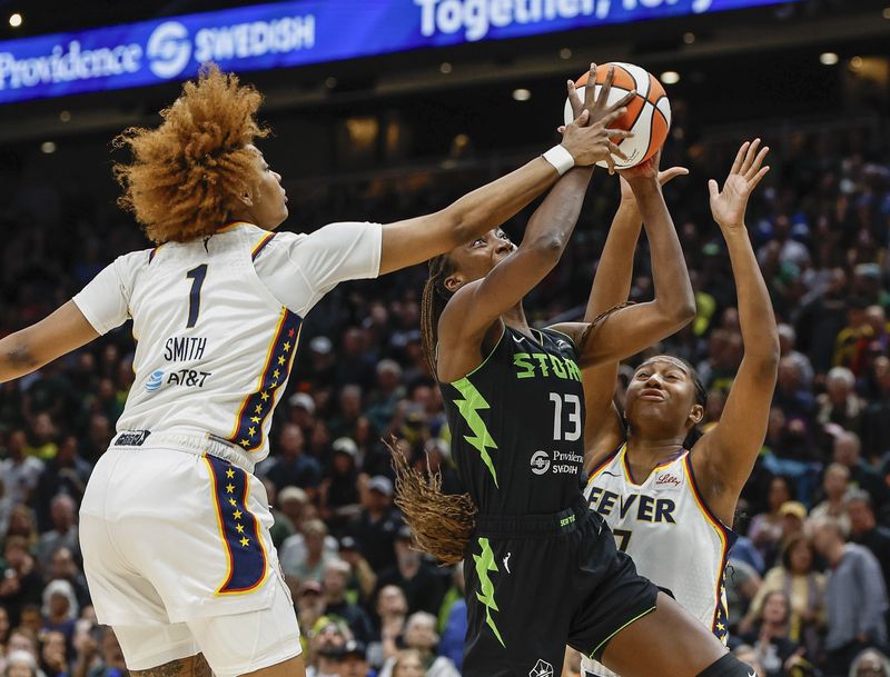 Indiana Fever's NaLyssa Smith gets the block on the shot by Seattle Storm's Ezi Magbegor during the first half of a WNBA basketball game Thursday, June 27, 2024, in Seattle. (Dean Rutz/The Seattle Times via AP)