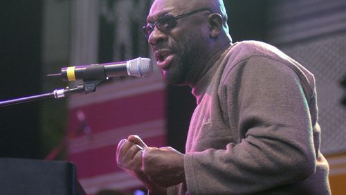 FILE - Isaac Hayes sings to a crowd of people at World of Music and Dance, a three day festival of music, arts and dance, July 27, 2001, in Redmond, Wash. (AP Photo/Frank Franklin II, File)