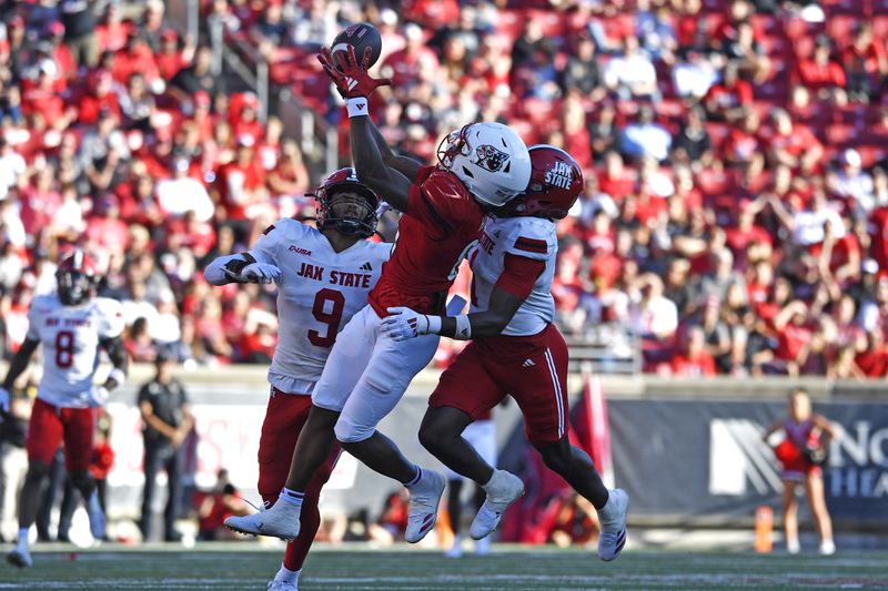 Louisville wide receiver Cataurus Hicks (81) makes a catch over the defense of Jacksonville State cornerback Geimere Latimer (1) during the second half of an NCAA college football game in Louisville, Ky., Saturday, Sept. 7, 2024. (AP Photo/Timothy D. Easley)