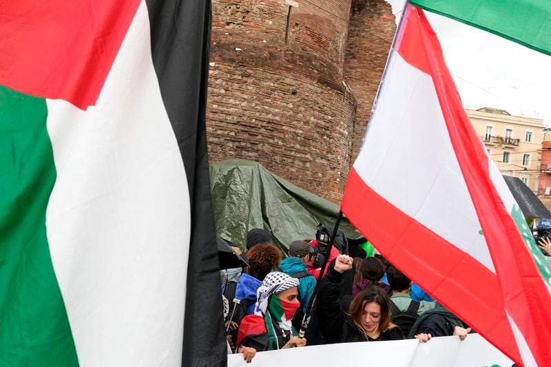 People attend at a protest in Rome, Saturday, Oct. 5, 2024. Pro-palestinians people take to the street in an unauthorised march in the centre of Rome two days ahead of the first anniversary of the Oct. 7. (AP Photo/Andrew Medichini)