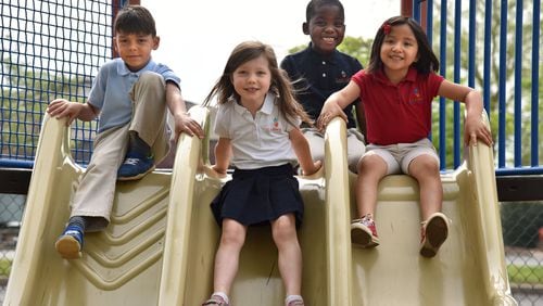 Kindergartners (from left) Ian DeOliviera, Adam Ajayi, Ximena Benitez and Eden Sterling, all 6, at Carman Adventist School in Marietta. HYOSUB SHIN / HSHIN@AJC.COM