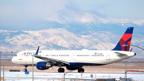 FILE - A Delta Airlines jetliner taxis on a runway at Denver International Airport after a winter storm swept through the region on Jan. 16, 2024, in Denver. Delta reports earnings on Thursday, July 11, 2024. (AP Photo/David Zalubowski)