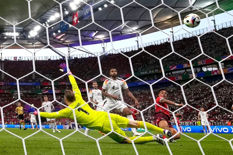 Switzerland's Dan Ndoye, front right, scores the opening goal during a Group A match between Switzerland and Germany at the Euro 2024 soccer tournament in Frankfurt, Germany, Sunday, June 23, 2024. (AP Photo/Frank Augstein)