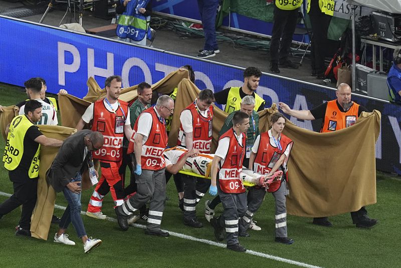 Hungary's Barnabas Varga is carted off the pitch after an injury during a Group A match between Scotland and Hungary at the Euro 2024 soccer tournament in Stuttgart, Germany, Sunday, June 23, 2024. (AP Photo/Ariel Schalit)