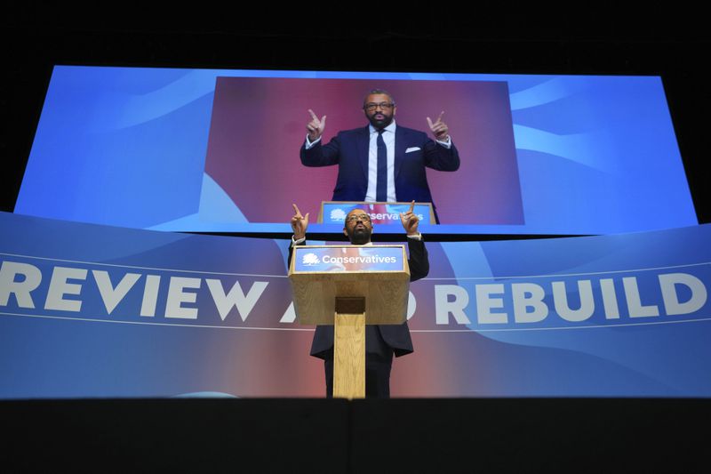 Conservative leadership candidate James Cleverly addresses members during the Conservative Party Conference at the International Convention Centre in Birmingham, England, Wednesday, Oct. 2, 2024.(AP Photo/Kin Cheung)