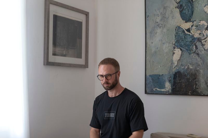 Andrei Hniot, a filmmaker and a prominent critic of the authoritarian government in Belarus, poses for a portrait in his apartment while under house arrest in Belgrade, Serbia, on Friday, Sept. 6, 2024. (AP Photo/Marko Drobnjakovic)