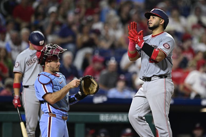 Washington Nationals' Keibert Ruiz, right, reacts after hitting a solo home run off Philadelphia Phillies' Orion Kerkering during the seventh inning of a baseball game, Thursday, Aug. 15, 2024, in Philadelphia. (AP Photo/Derik Hamilton)