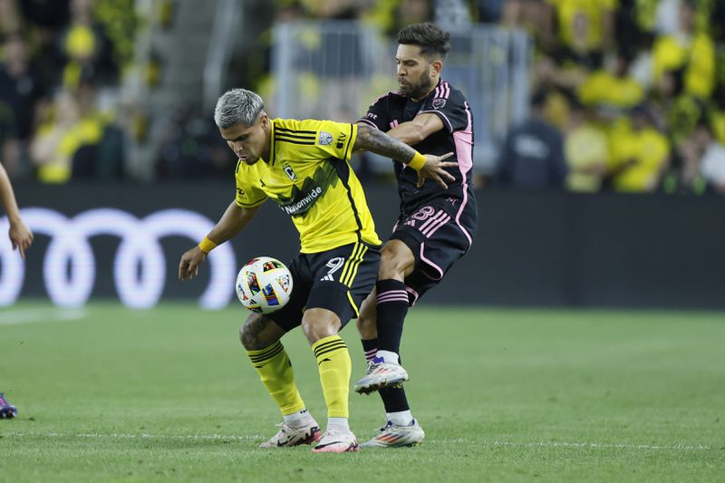 Columbus Crew's Cucho Hernandez, left, keeps the ball away from Inter Miami's Jordi Alba during the first half of an MLS soccer match Wednesday, Oct. 2, 2024, in Columbus, Ohio. (AP Photo/Jay LaPrete)