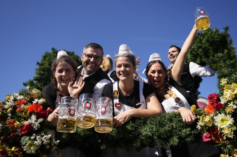 The Oktoberfest hosts arrive for the start of the 189th 'Oktoberfest' beer festival in Munich, Germany, Saturday, Sept. 21, 2024. (AP Photo/Matthias Schrader)