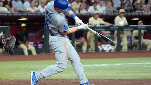 Los Angeles Dodgers' Will Smith connects for a three-run home run against the Arizona Diamondbacks during the seventh inning of a baseball game Friday, Aug. 30, 2024, in Phoenix. (AP Photo/Ross D. Franklin)