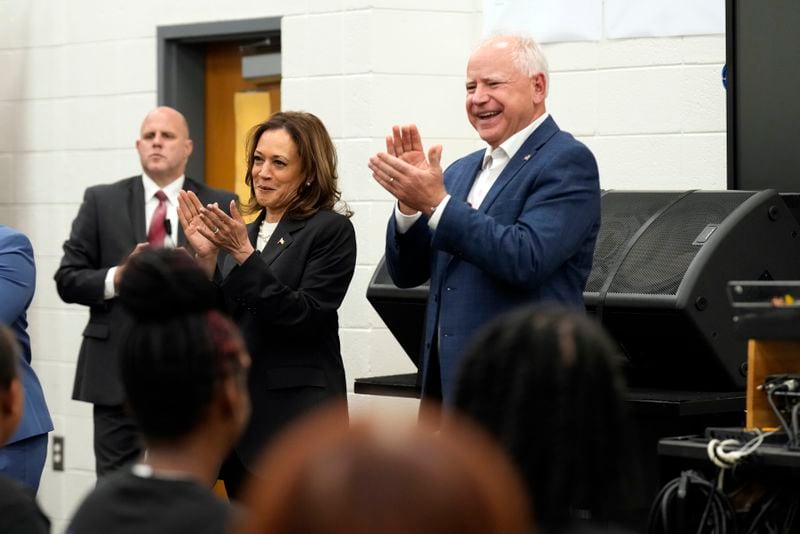 Democratic presidential nominee Vice President Kamala Harris and Democratic vice presidential candidate Minnesota Gov. Tim Walz speak to marching band members at Liberty County High School in Hinesville, Ga., Wednesday, Aug. 28, 2024. (AP Photo/Jacquelyn Martin)