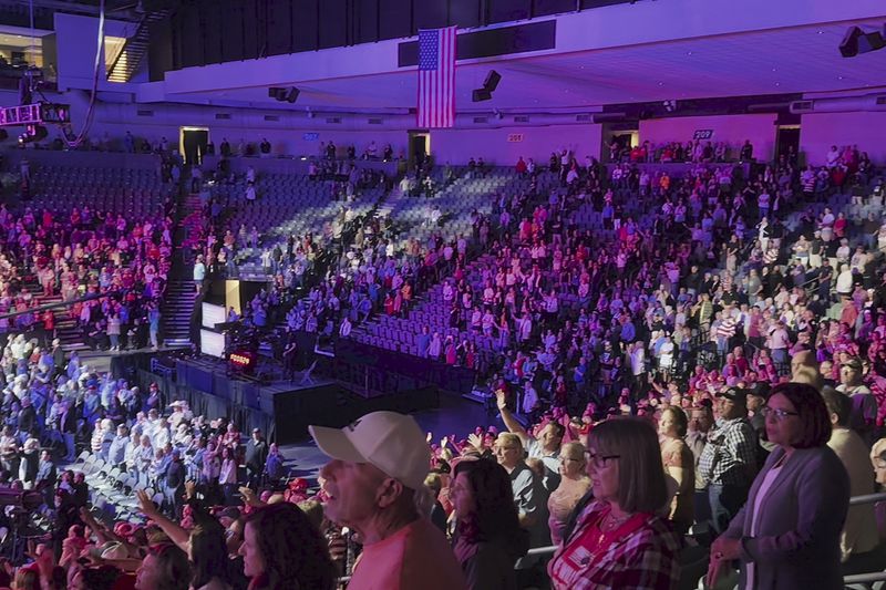 Attendees at the Opening the Heavens conference recite the "Watchman Decree," displayed on large screens and including a pledge to "take back and permanently control" positions of leadership in major areas of society, at the Mid-America Center in Council Bluffs, Iowa, on Friday, Sept. 13, 2024. (AP Photo/Peter Smith)