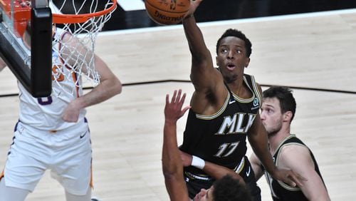 May 5, 2021 Atlanta - Atlanta Hawks forward Onyeka Okongwu (17) blocks a shot by Phoenix Suns forward Cameron Johnson (foreground) during the first half in an NBA basketball game at State Farm Arena on Wednesday, May 5, 2021. (Hyosub Shin / Hyosub.Shin@ajc.com)