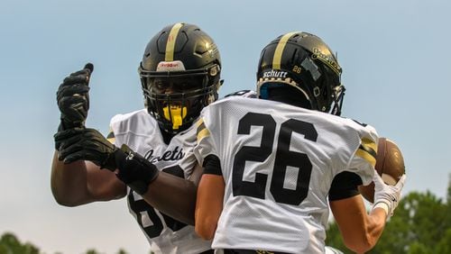 Sprayberry’s defensive tackle, David Giwa, and running back, Ian Hulbert, celebrate a touchdown during the Sprayberry at Kennesaw Mountain high school football game in Kennesaw, GA on August 30, 2024. (Jamie Spaar for the Atlanta Journal Constitution)