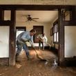 FILE - Ben Phillips, left, and his wife Becca Phillips scrape mud out of the living room of their home left in the wake of Hurricane Helene, Oct. 1, 2024, in Marshall, N.C. (AP Photo/Jeff Roberson, File)