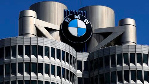 FILE - The logo of German car manufacturer BMW is fixed at the headquarters in Munich, Germany, Friday, May 14, 2021. (AP Photo/Matthias Schrader, File)