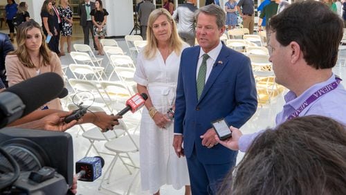 Gov. Brian Kemp and first lady Marty Kemp talk to reporters after a press conference at Ola High School in Henry County on Friday, July 29, 2022, when Kemp announced $125 classroom supply grants for teachers and other school staff. (Steve Schaefer / steve.schaefer@ajc.com)