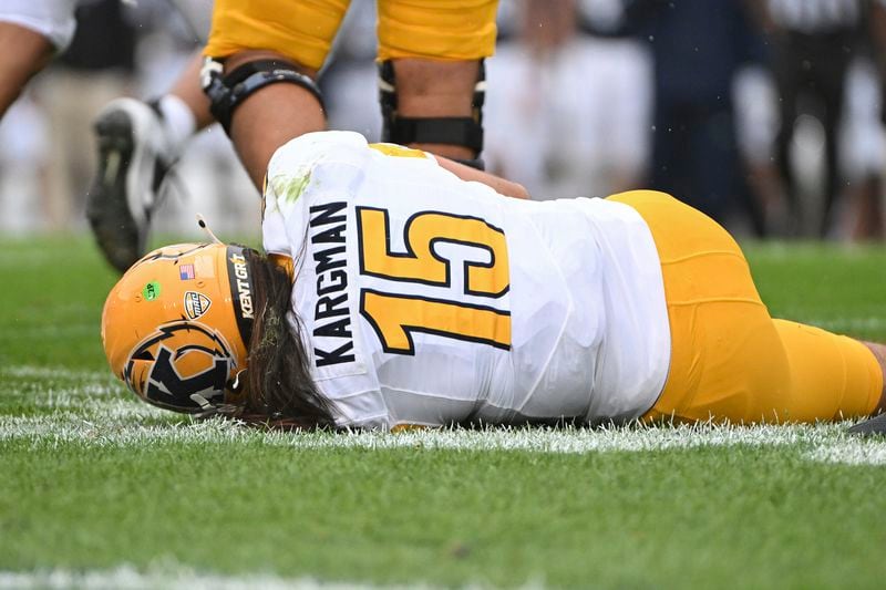 Kent State quarterback Devin Kargman lays on the field injured during the first quarter of an NCAA college football game against Penn State, Saturday, Sept. 21, 2024, in State College, Pa. (AP Photo/Barry Reeger)