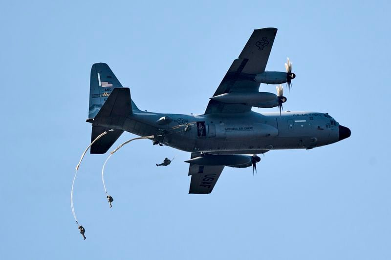 Parachutists jump over Ginkel Heath Netherlands, Saturday, Sept. 21, 2024, to mark the 80th anniversary of an audacious by unsuccessful World War II mission codenamed Market Garden to take key bridges in the Netherlands. (AP Photo/Phil Nijhuis)