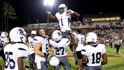 September 6, 2019 - Snellville, Ga: South Gwinnett quarterback Tre Truitt (1) celebrates with Caleb Pedro (27) after they defeated Brookwood 35-21 at Brookwood High School Friday, September 6, 2019 in Snellville, Ga.. (JASON GETZ/SPECIAL TO THE AJC)