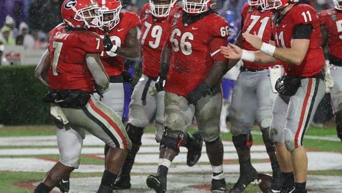 Georgia tailback D’Andre Swift (left) celebrates his second touchdown run against Kentucky on Oct. 19 in Athens.