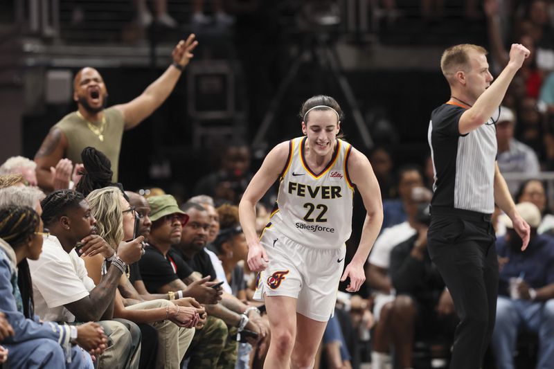 Indiana Fever guard Caitlin Clark (22) reacts after making a shot against the Atlanta Dream during the first half at State Farm Arena, Friday, June 21, 2024, in Atlanta. (Jason Getz / AJC)

