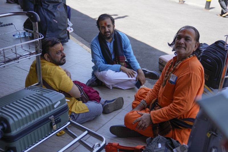 Stranded passengers wait for their delayed flights out of JKIA airport after flights were grounded following workers’ protesting a planned deal between the government and a foreign investor, in Nairobi, Kenya, Wednesday, Sept. 11, 2024. (AP Photo/Brian Inganga)