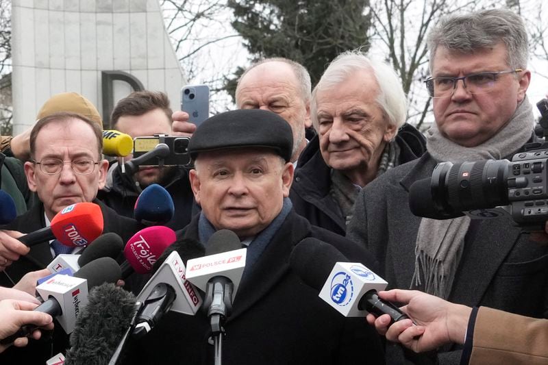 FILE - Opposition leader Jaroslaw Kaczynski and two prominent members of his right-wing Law and Justice party who have been sentenced to prison terms for abuse of power and had their parliament mandates waved, Mariusz Kaminski, left, and Maciej Wasik, right, talk to reporters after they tried to forcefully enter parliament, claiming they still are lawmakers, before the parliament building, in Warsaw, Poland, on Feb. 7, 2024. (AP Photo/Czarek Sokolowski, File)