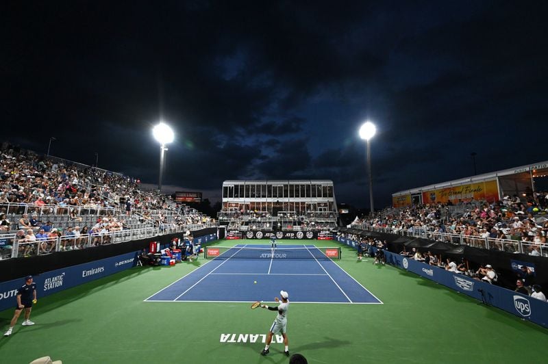 Frances Tiafoe (Hyattsville, MD, USA), background, plays against Yoshihito Nishioka (Mie, Japan) during a quarterfinal match at the 2024 Atlanta Tennis Open at Atlantic Station on Friday, July 26, 2024 in Atlanta. (Hyosub Shin / AJC)