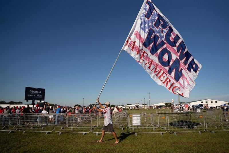 A man carries a flag stating that "TRUMP WON" before a rally in September where former President Donald Trump promoted candidates he endorsed to challenge Republicans incumbents in Georgia. State GOP Chairman David Shafer also spoke at the rally, even though the party's bylaws require its top official to remain neutral in primary fights. (Sean Rayford/Getty Images/TNS)