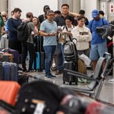 The Delta Baggage Service saw long lines Monday morning and clusters of passengers sleeping on backpacks and folded blankets were spread throughout the Hartsfield-Jackson International Airport domestic terminal Monday morning, July 22, 2024. By Monday morning, travel disruptions caused by a flawed cybersecurity update showed that Hartsfield-Jackson had the most flights canceled on Monday out of the airports FlightAware tracks. (John Spink/AJC)