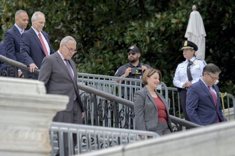 From left, House Minority Leader Hakeem Jeffries, D-N.Y., House Majority Leader Steve Scalise, R-La., Senate Majority Leader Chuck Schumer, D-N.Y., Sen. Amy Klobuchar, D-Minn., and Speaker of the House Mike Johnson, R-La., arrive to the First Nail Ceremony marking the beginning of construction of the 2025 Presidential Inauguration platform, on the steps of the Capitol, Wednesday, Sept. 18, 2024, in Washington. (AP Photo/Mariam Zuhaib)