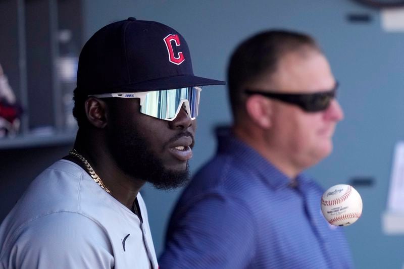 Cleveland Guardians' Jhonkensy Noel, left, tosses a ball in the air as he stands in the dugout during the third inning of a baseball game against the Los Angeles Dodgers, Sunday, Sept. 8, 2024, in Los Angeles. (AP Photo/Mark J. Terrill)