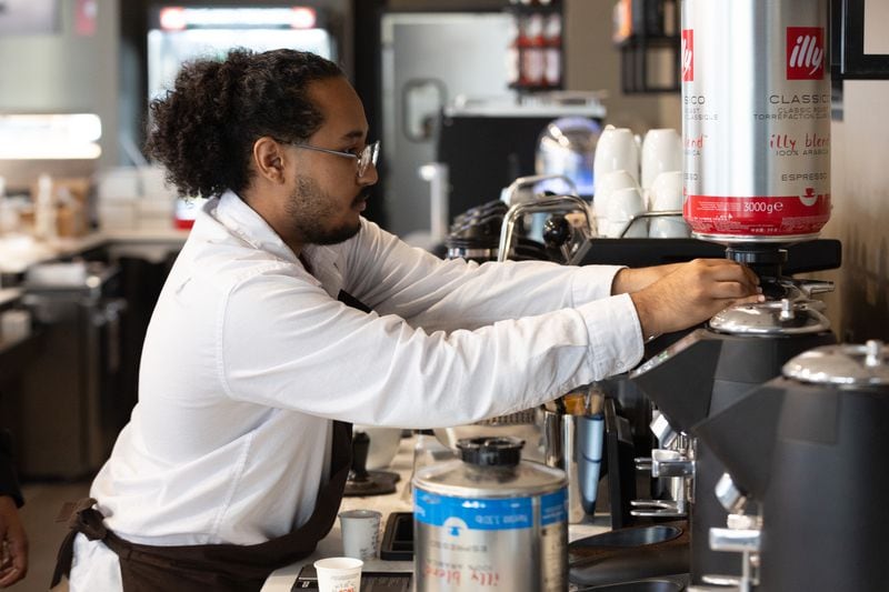 Barista Sanni Mohammed works on getting ready for Thursday's grand opening of Illy Coffee Shop at the Atlantic Station on Tuesday, Nov. 14, 2023.   (Steve Schaefer/steve.schaefer@ajc.com).